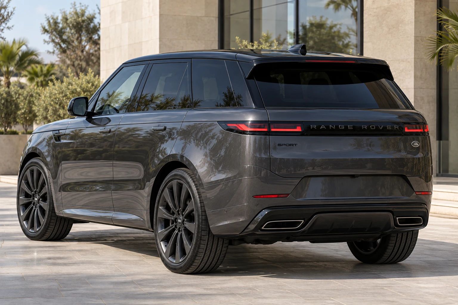 Dark grey 2026 Range Rover Sport rental SUV, rear three-quarter view
