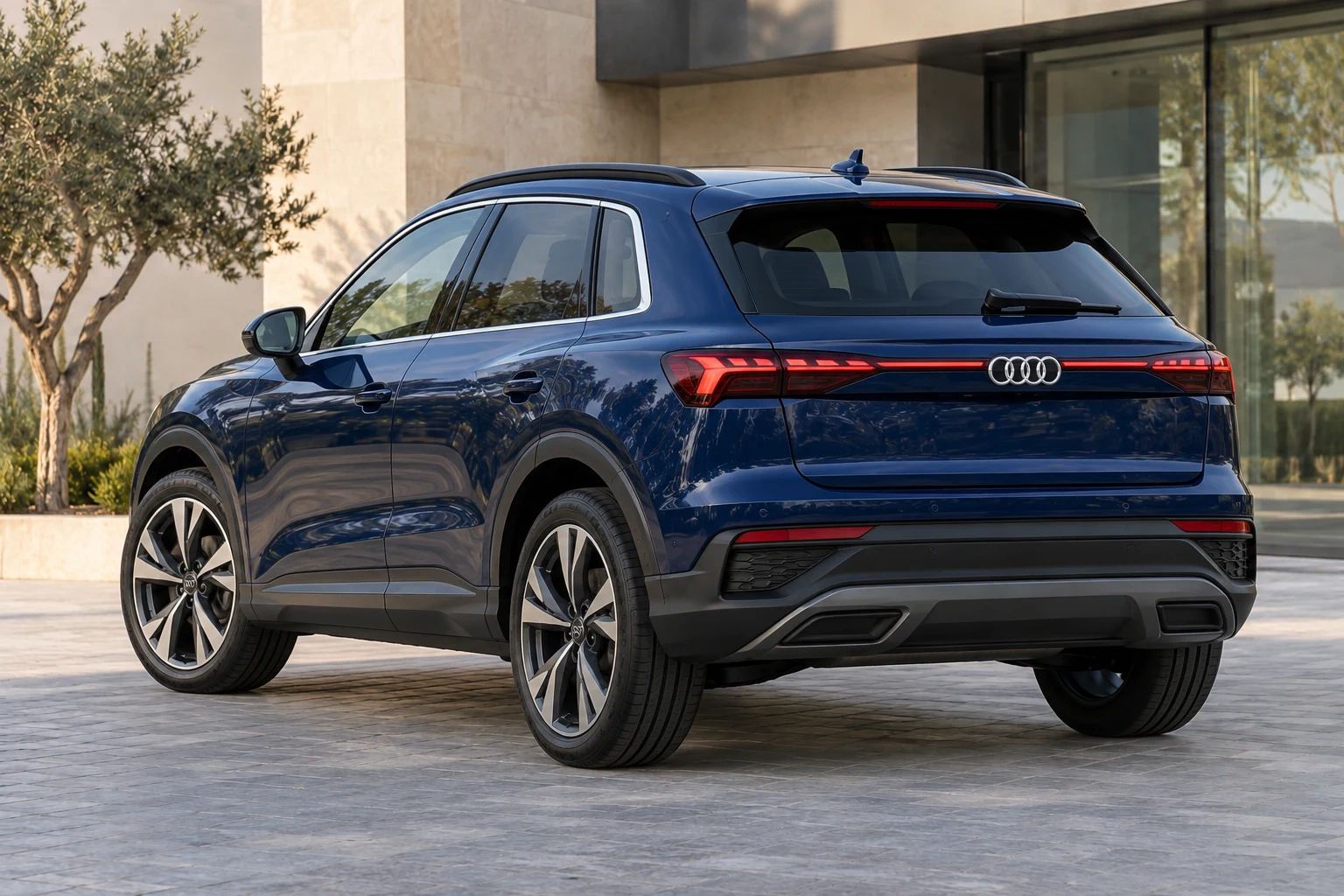 Blue 2026 Audi Q3 rental SUV, rear three-quarter view